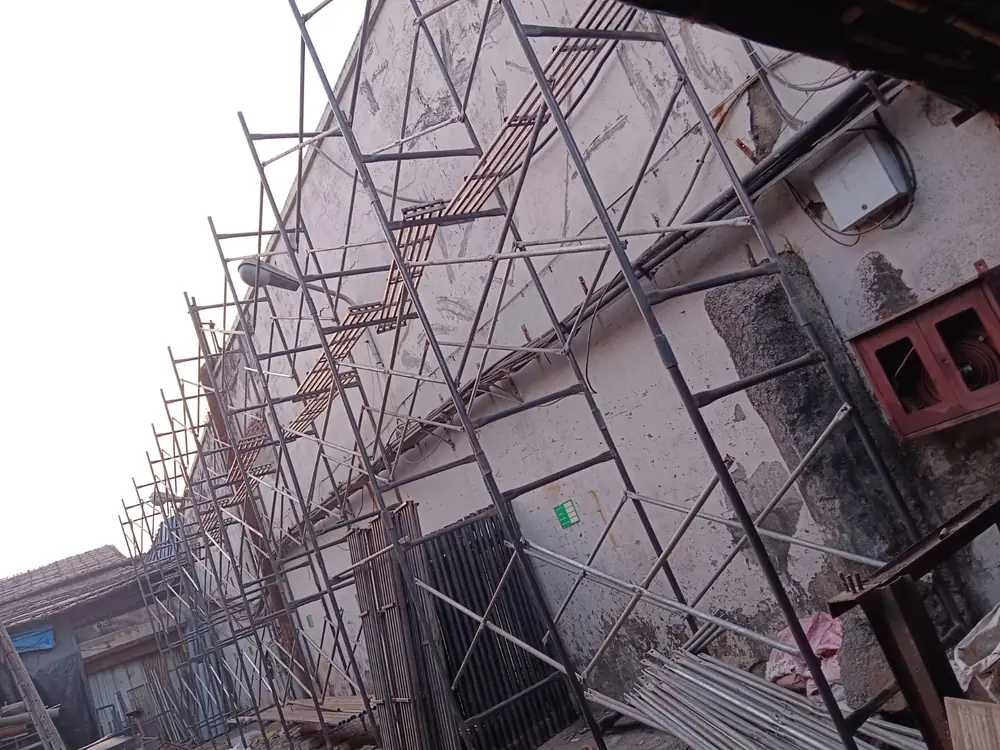 Scaffolding installed along a residential building exterior