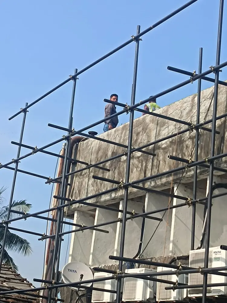 Workers assembling a temporary scaffolding access structure